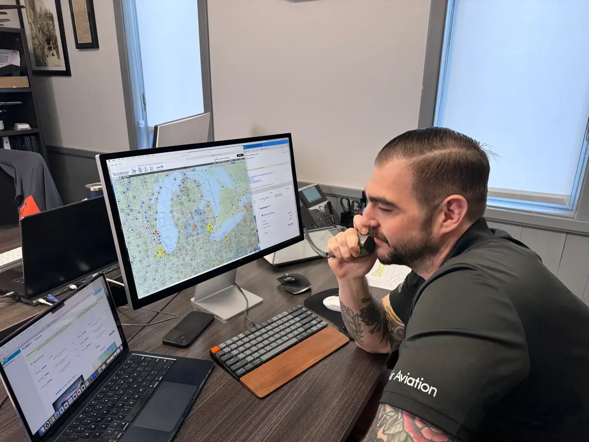 A WAir trip planner on the phone at a flight-tracking screen